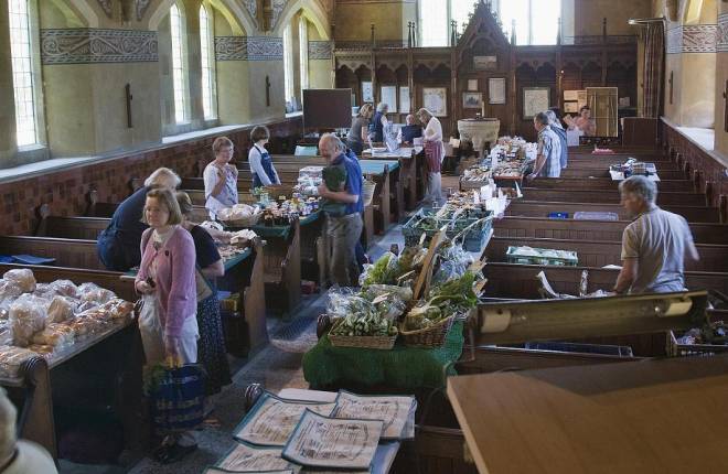 people shopping at Farmers market inside church 